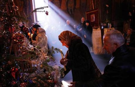 A Romanian woman held a burning candle in the Orthodox church of Malaia village, about 150 miles north-west of Bucharest, Romania.

